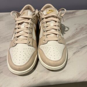 Nike Low-Top Sneakers in Cream & Metallic Gold Accents